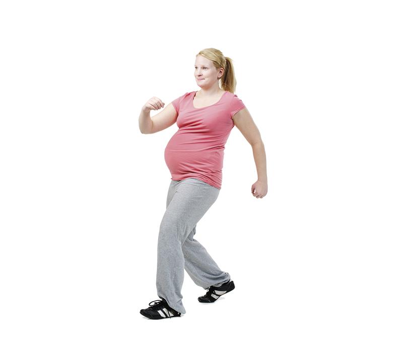 A pregnant woman is doing mambo steps.