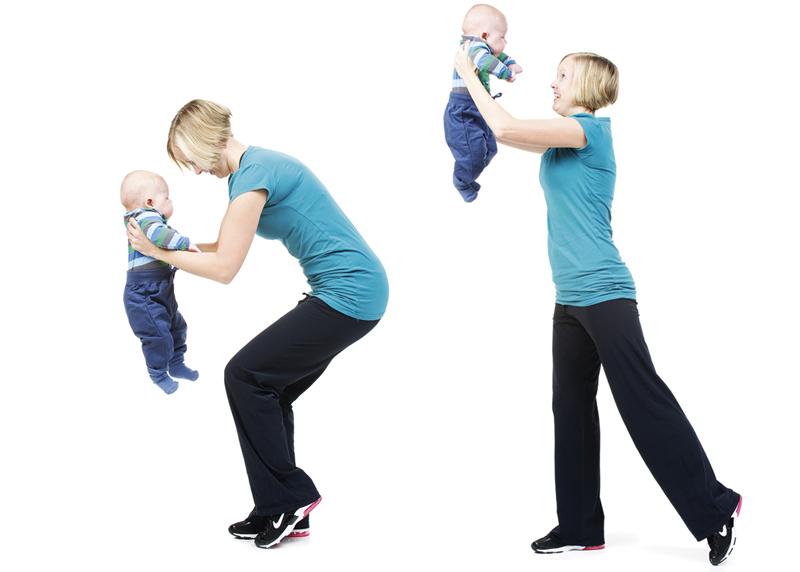 A woman is holding her baby while rounding and extending the body.
